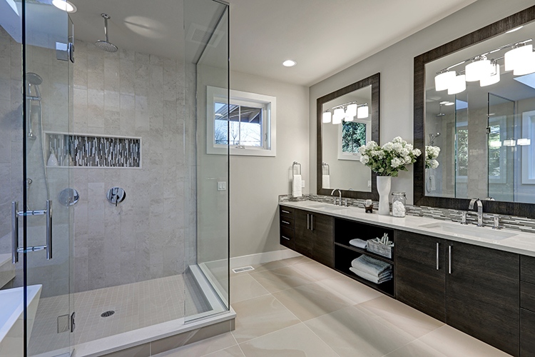 Spacious bathroom in gray tones with heated floors, walk-in shower, double sink vanity and skylights. Northwest, USA