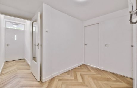empty interior area with white walls laminate flooring scaled 1